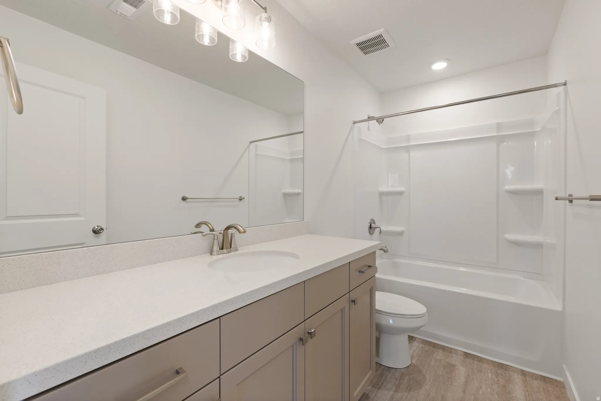 Bathroom featuring a long vanity with light-toned cabinetry and a white countertop