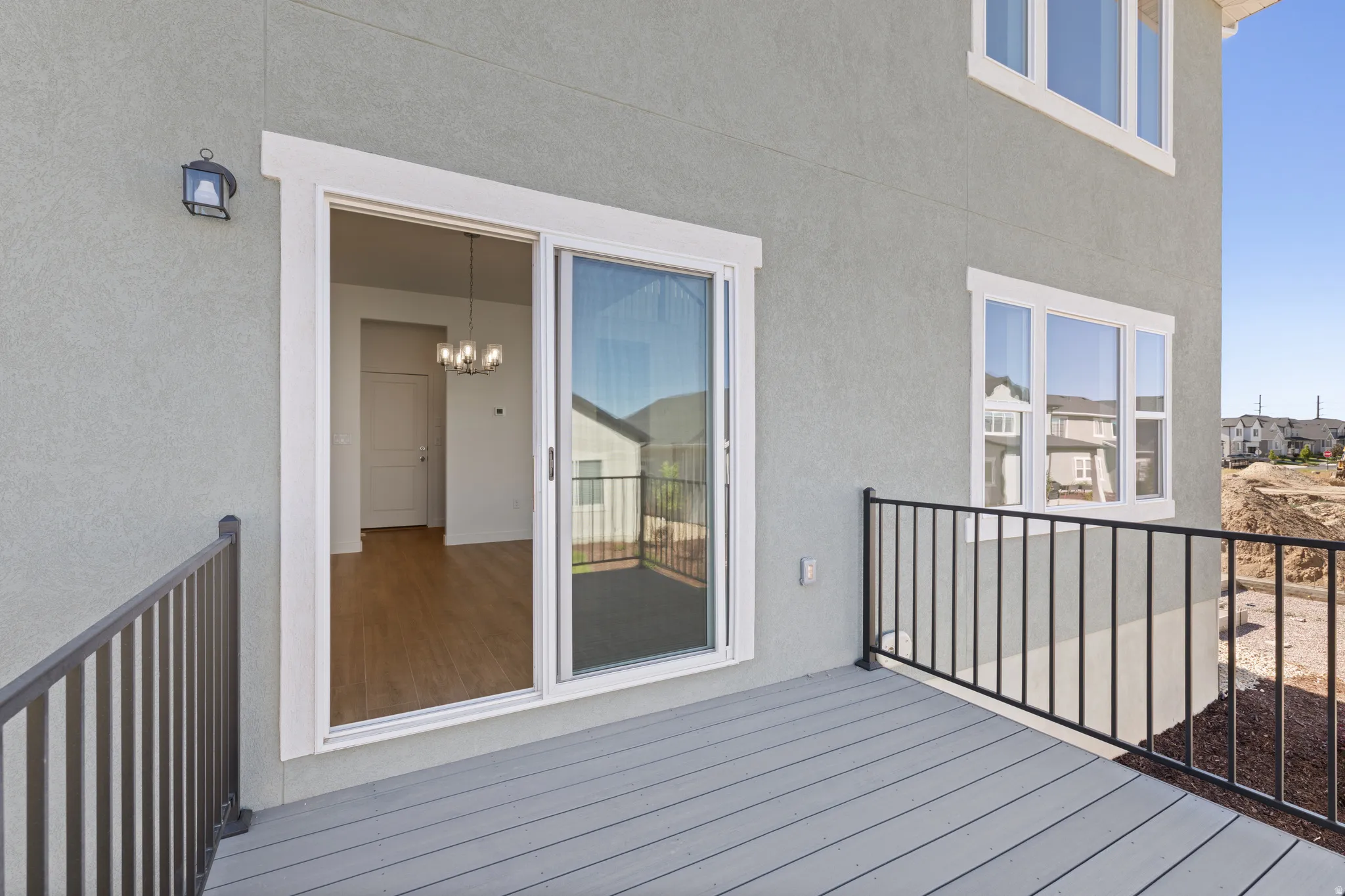 Exterior deck featuring composite decking and black metal railings