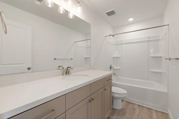 Bathroom featuring a long vanity with light-toned cabinetry and a white countertop