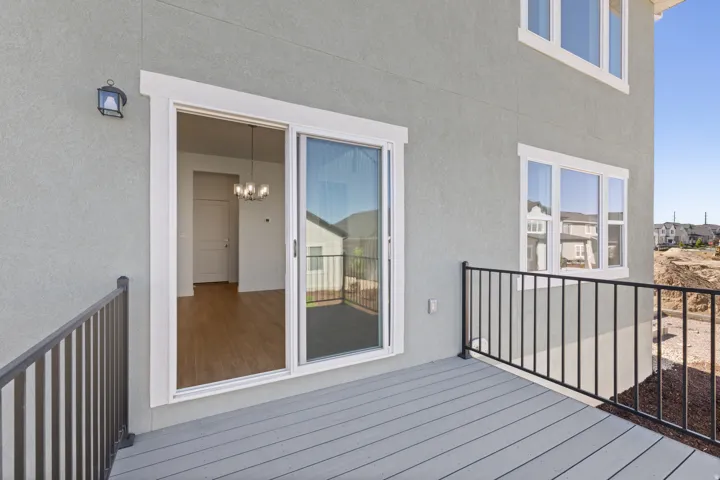Exterior deck featuring composite decking and black metal railings