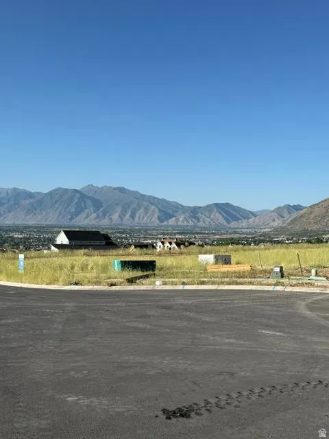 Expansive mountain range backdrop and distant city lights