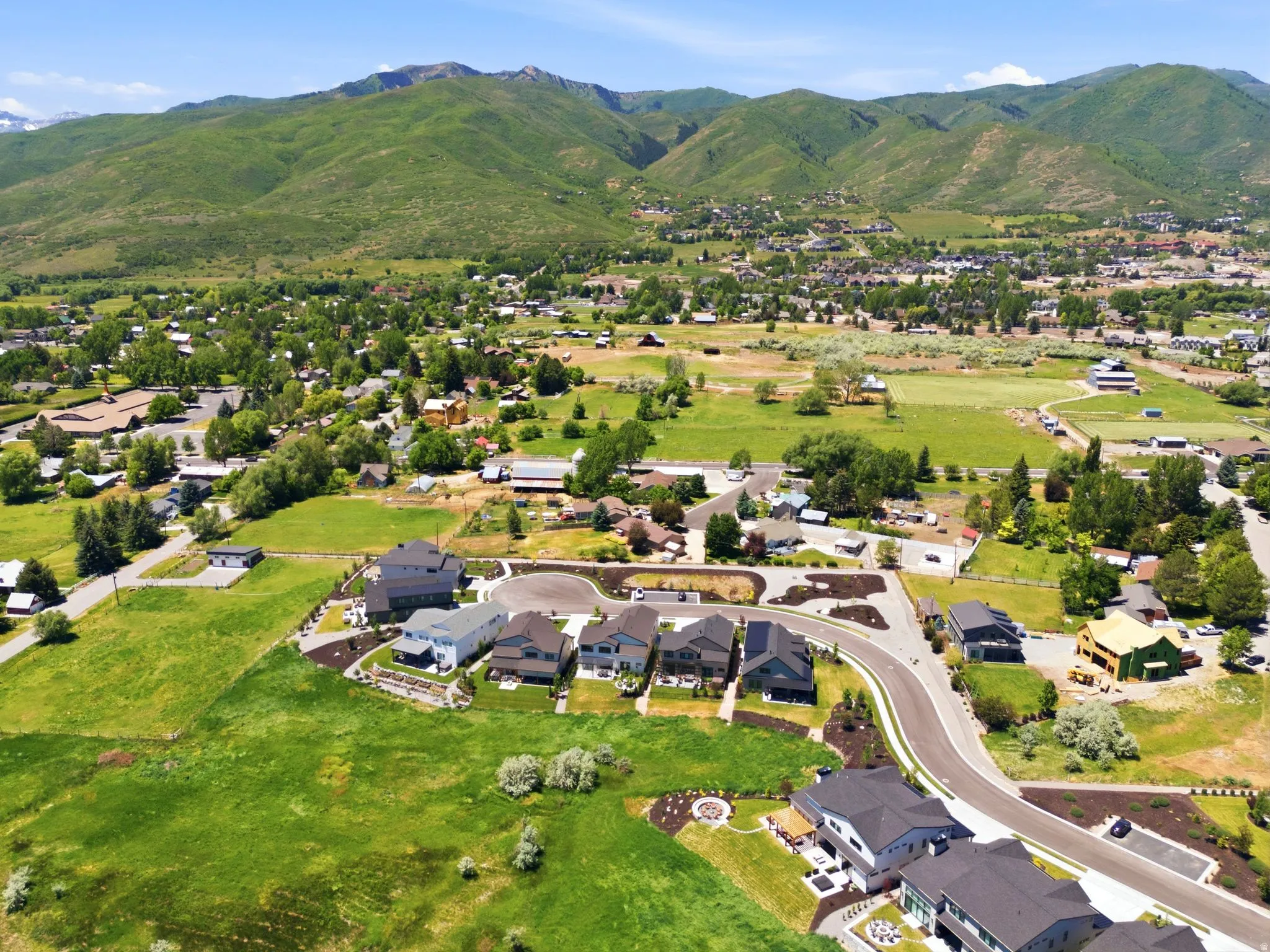 Residential properties situated on a curving street, offering mountain and valley views