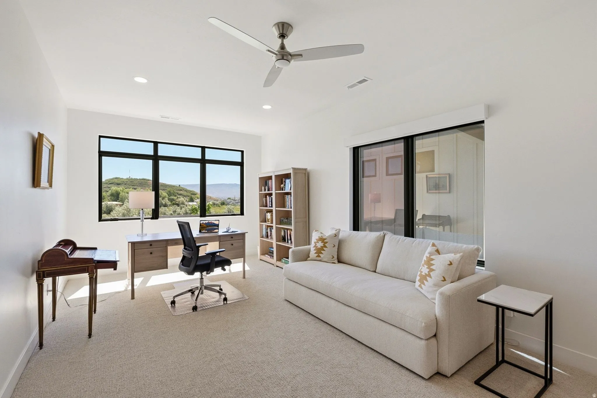 Room featuring light-colored carpeting and white walls