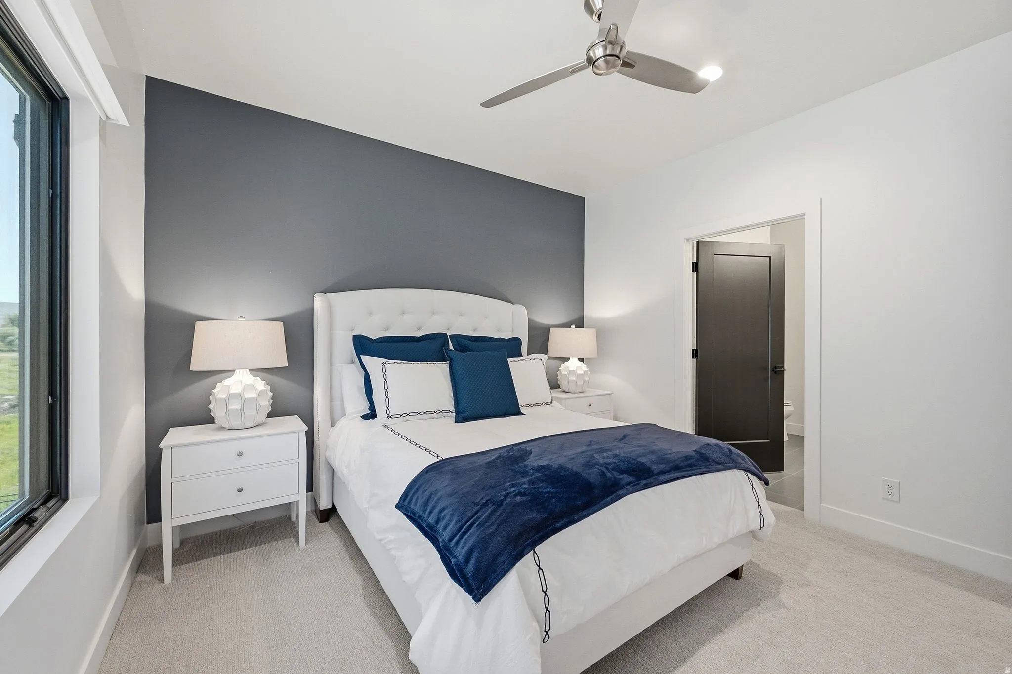 White upholstered headboard set against a contemporary accent wall