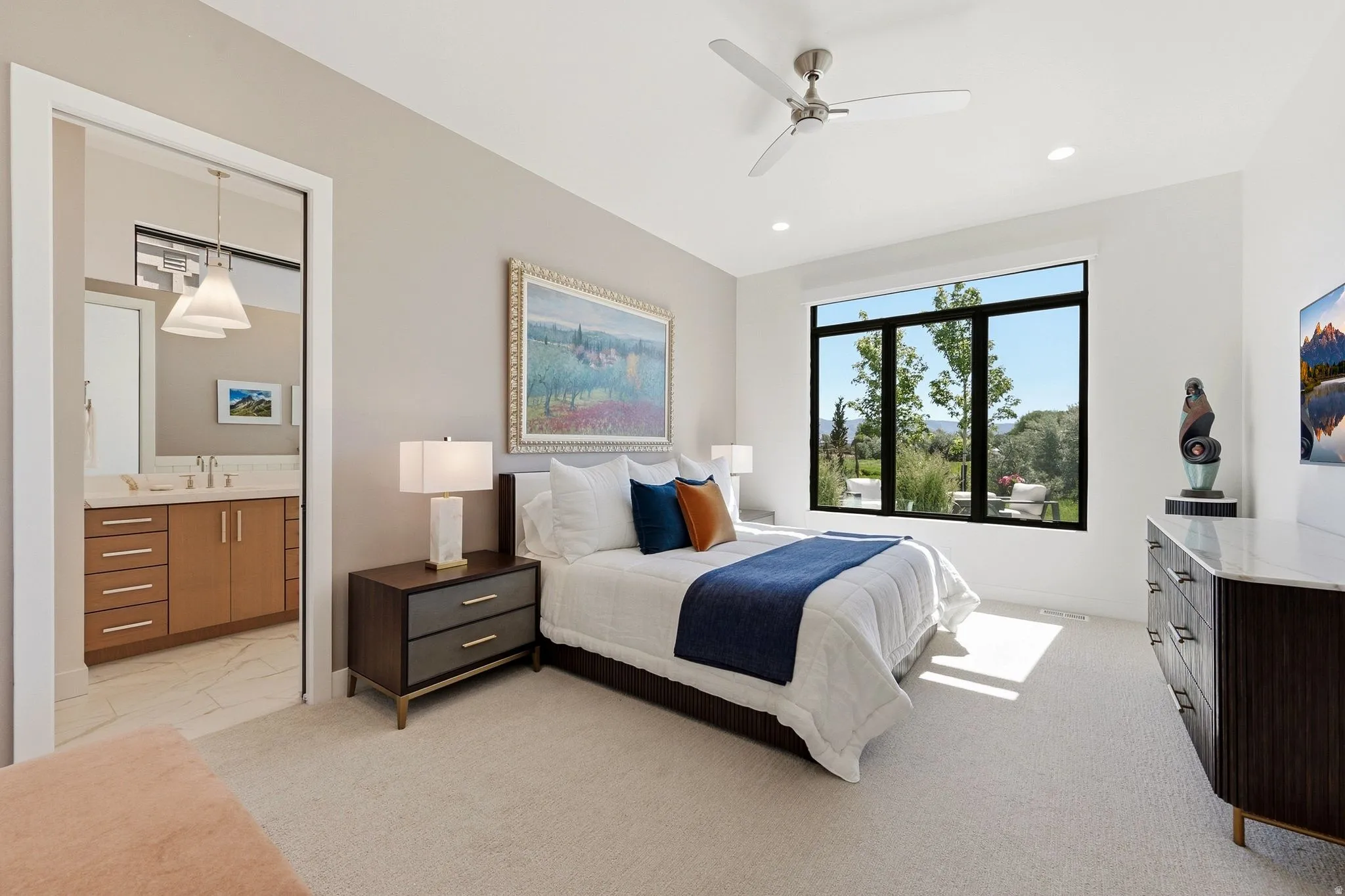 Bright room featuring a large window, recessed lighting, and a ceiling fan
