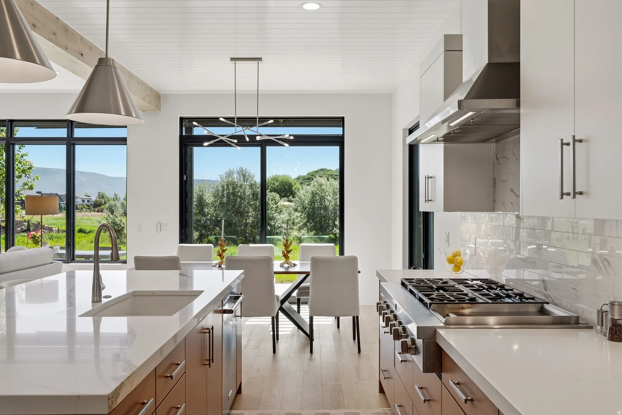 Gourmet kitchen featuring a large gas range, stainless steel appliances, and wood-finish flooring