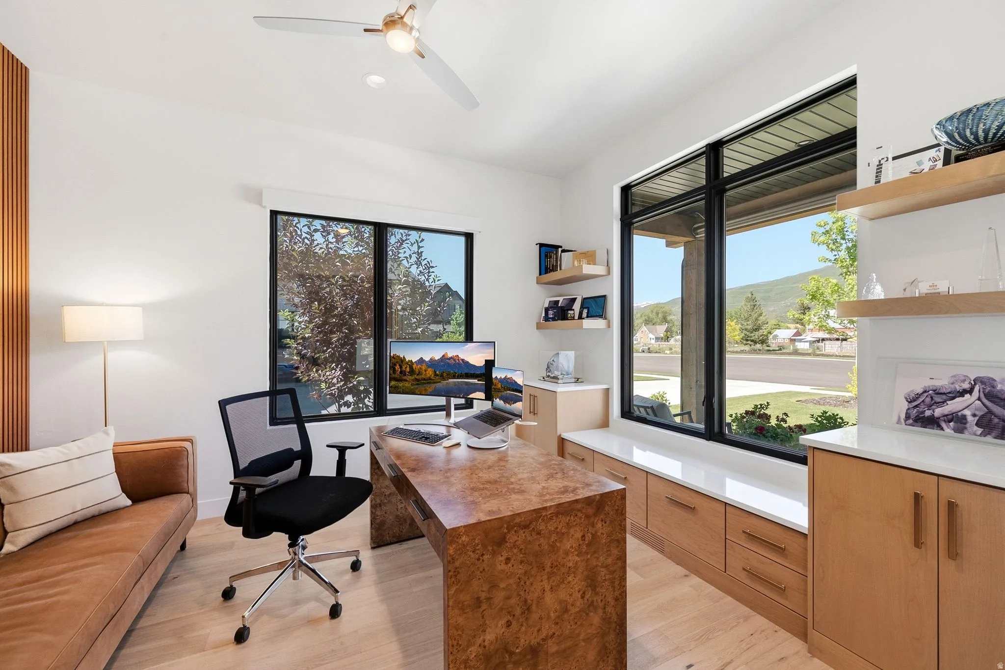 Light wood-finish flooring complements white walls with a vertical wood slat accent