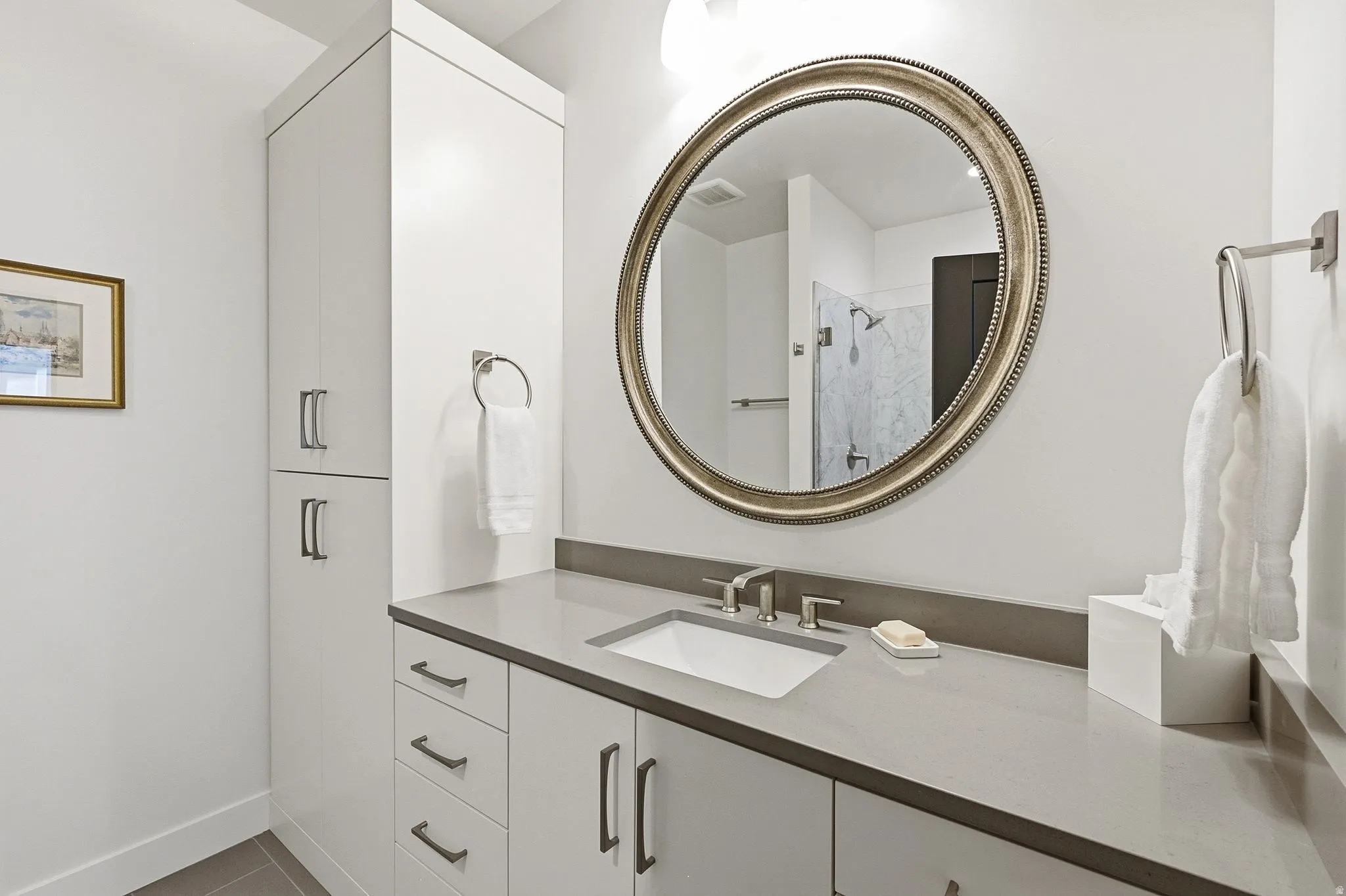 Modern vanity with a rectangular undermount sink and a light gray countertop