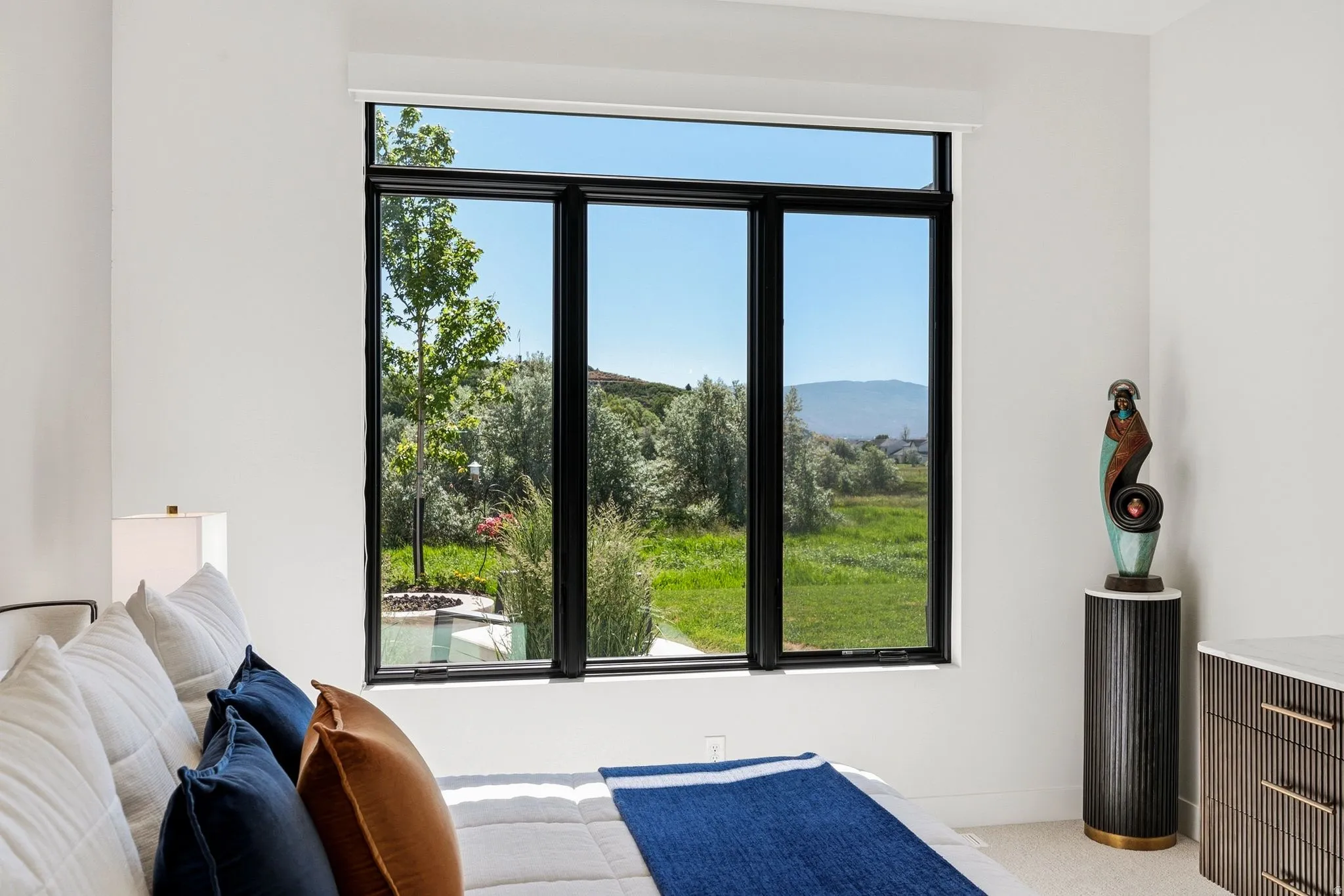Expansive window with black framing, providing abundant natural light