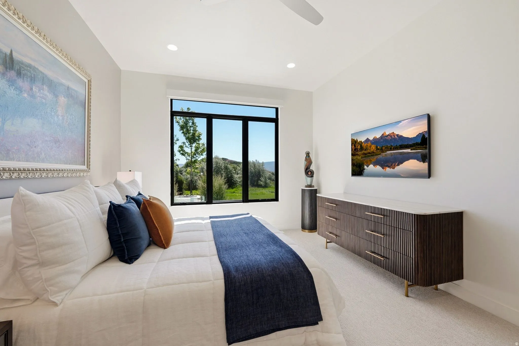 Expansive bedroom featuring wall-to-wall carpeting and a large multi-pane window