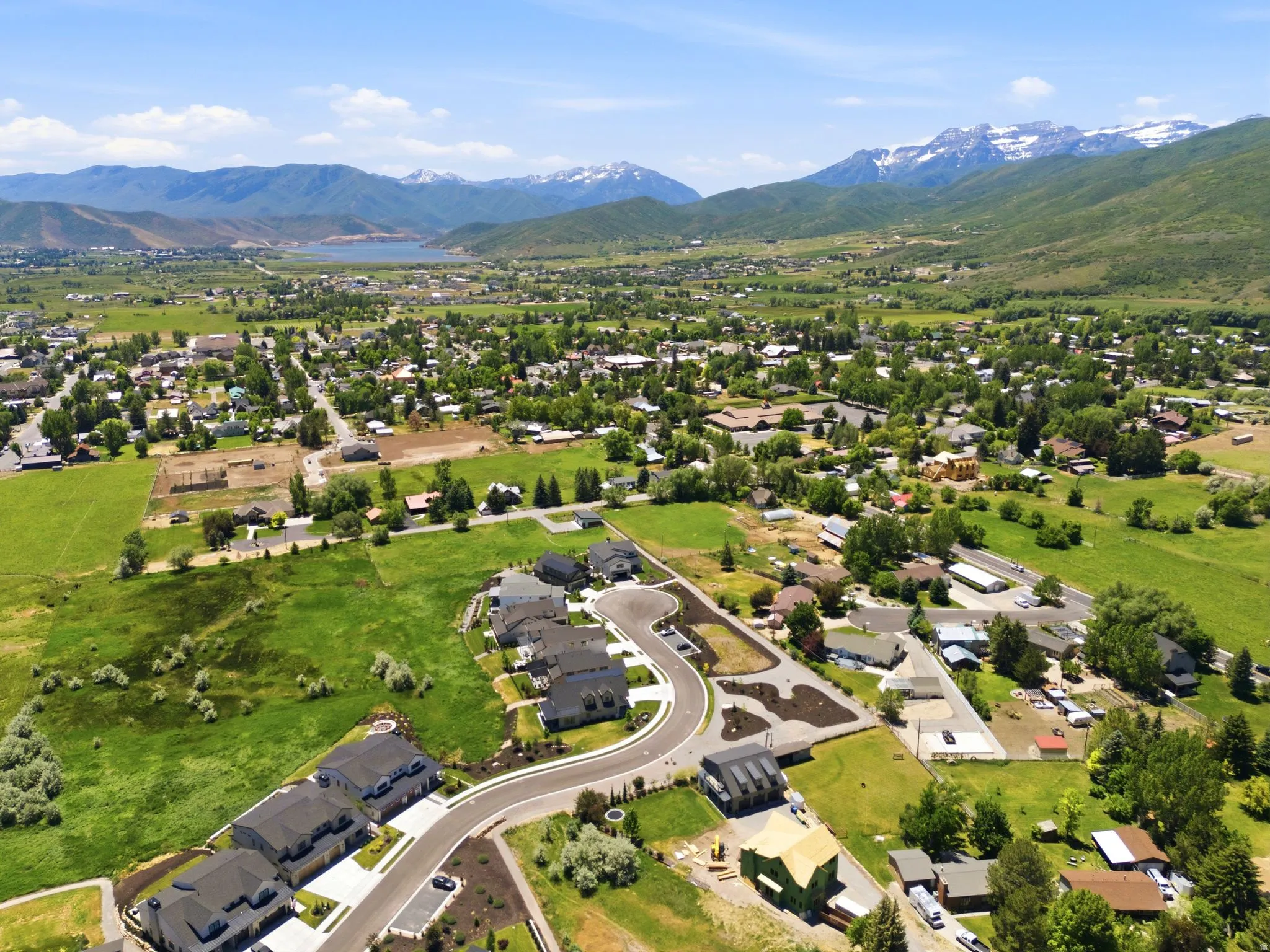 Expansive aerial showcasing a developing community with established homes and new construction