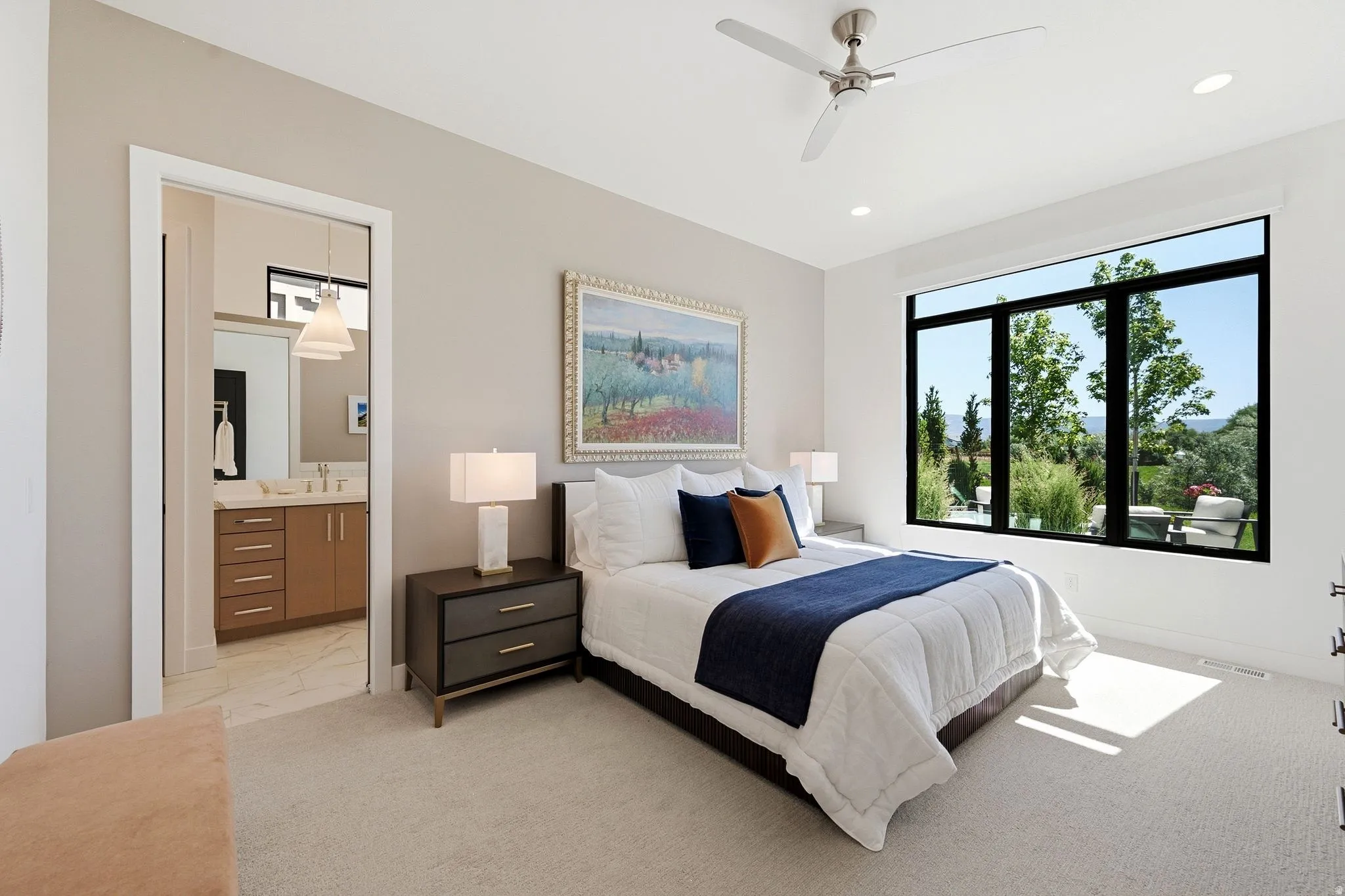Bedroom featuring an expansive window with black framing, recessed lighting, and a ceiling fan