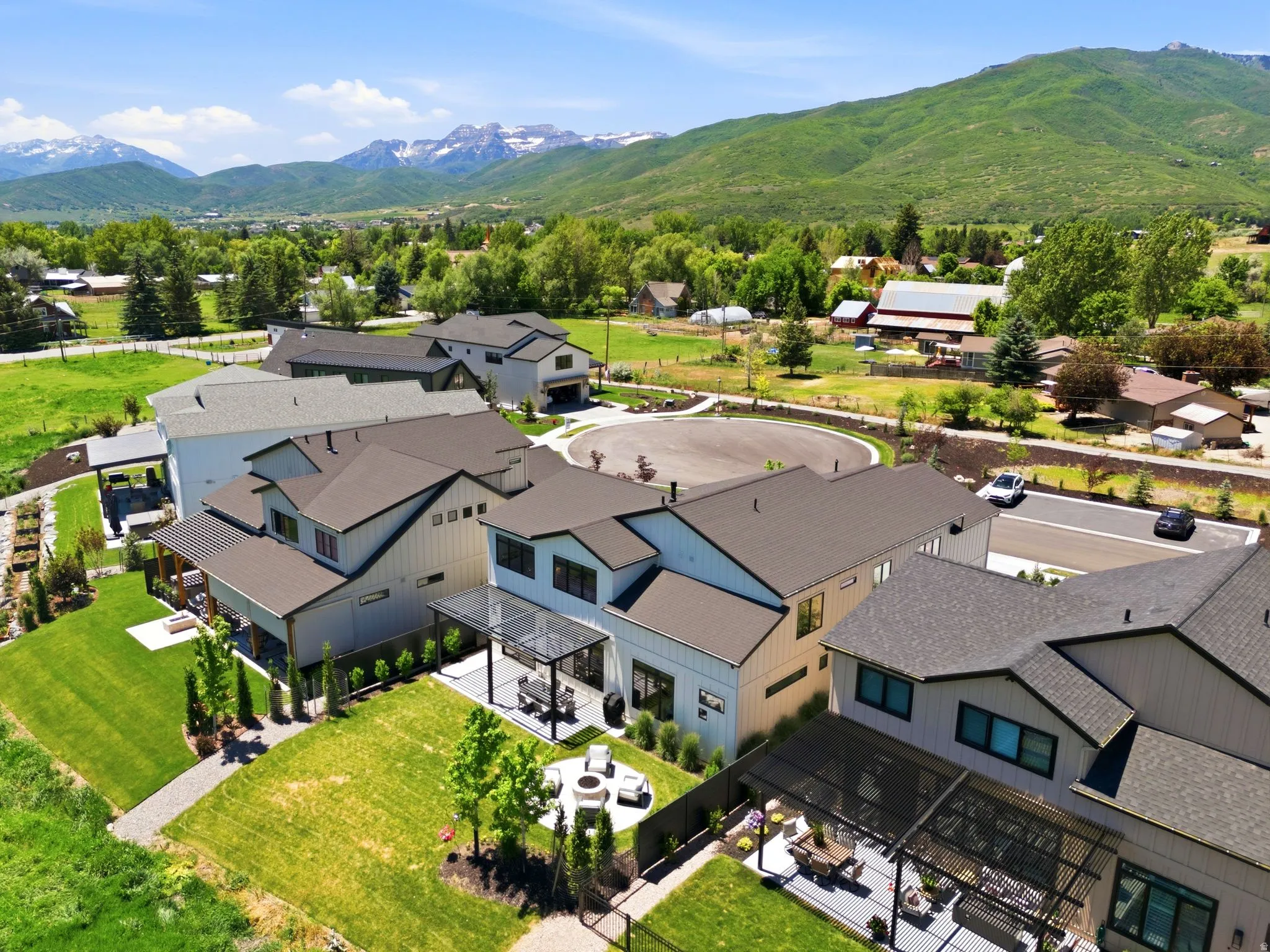 Contemporary residences featuring striking dark roofs and light-colored siding