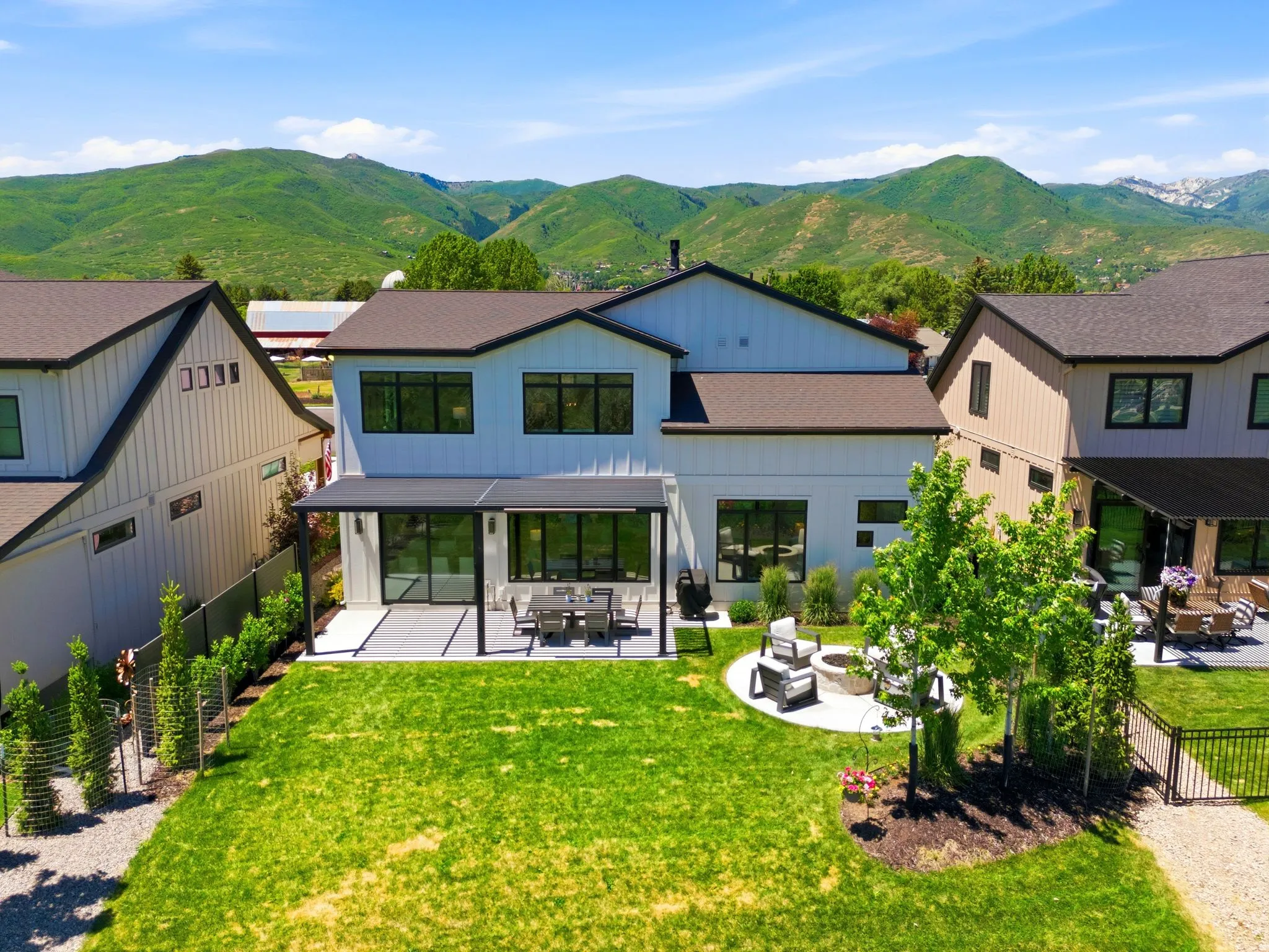 Contemporary two-story residence featuring a board and batten facade and dark trim accents