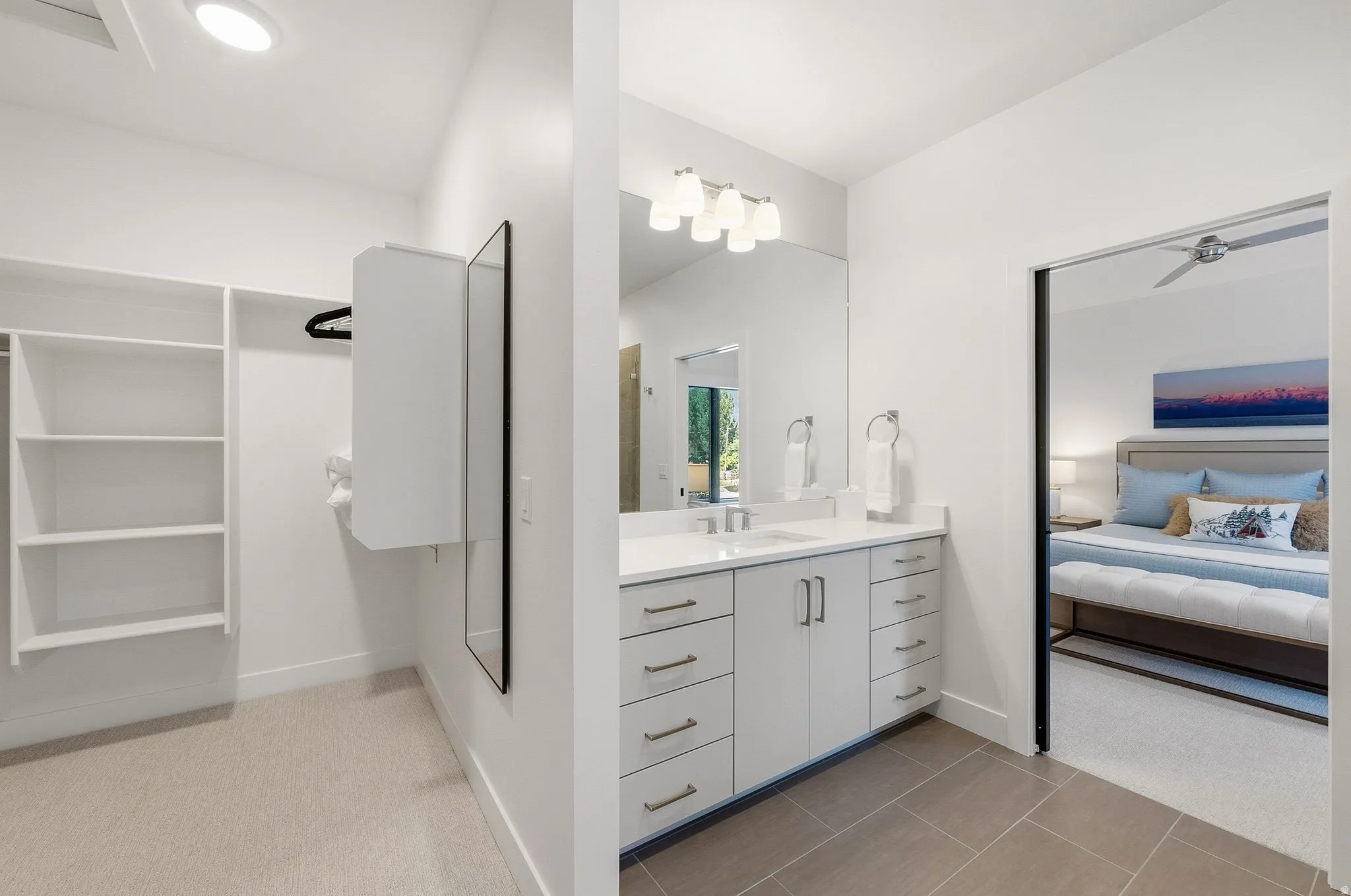 Contemporary bathroom vanity with a single sink, quartz countertop, and integrated mirror