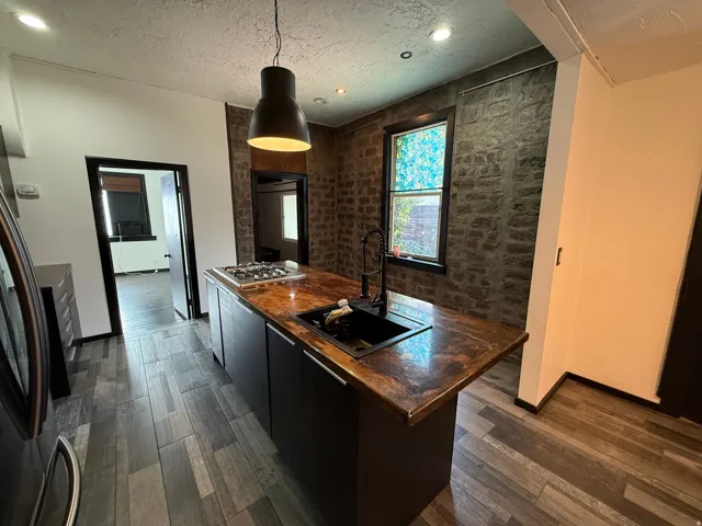 Kitchen island with a built-in gas cooktop and integrated sink