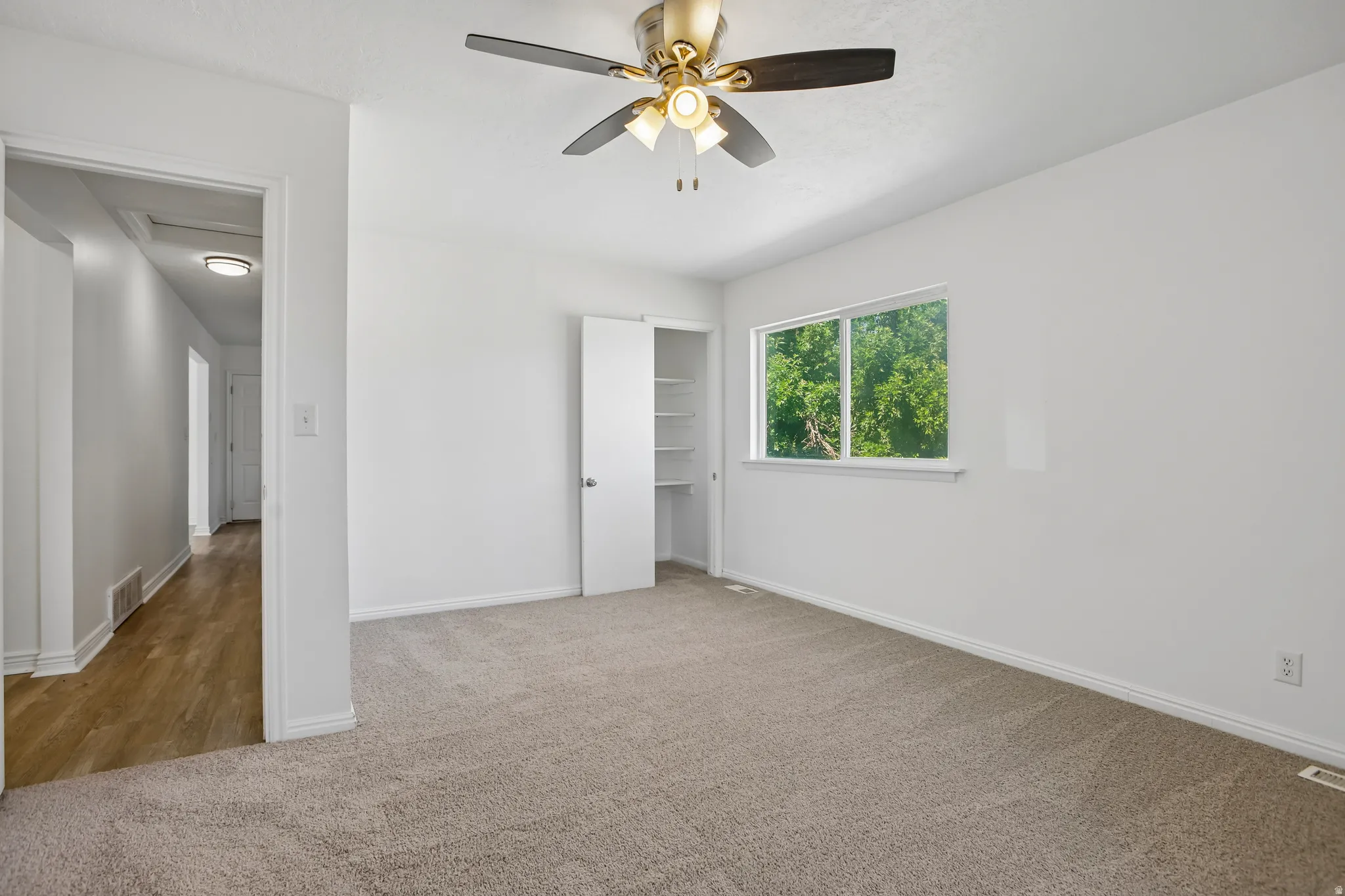 Neutral-toned carpeting paired with white baseboards