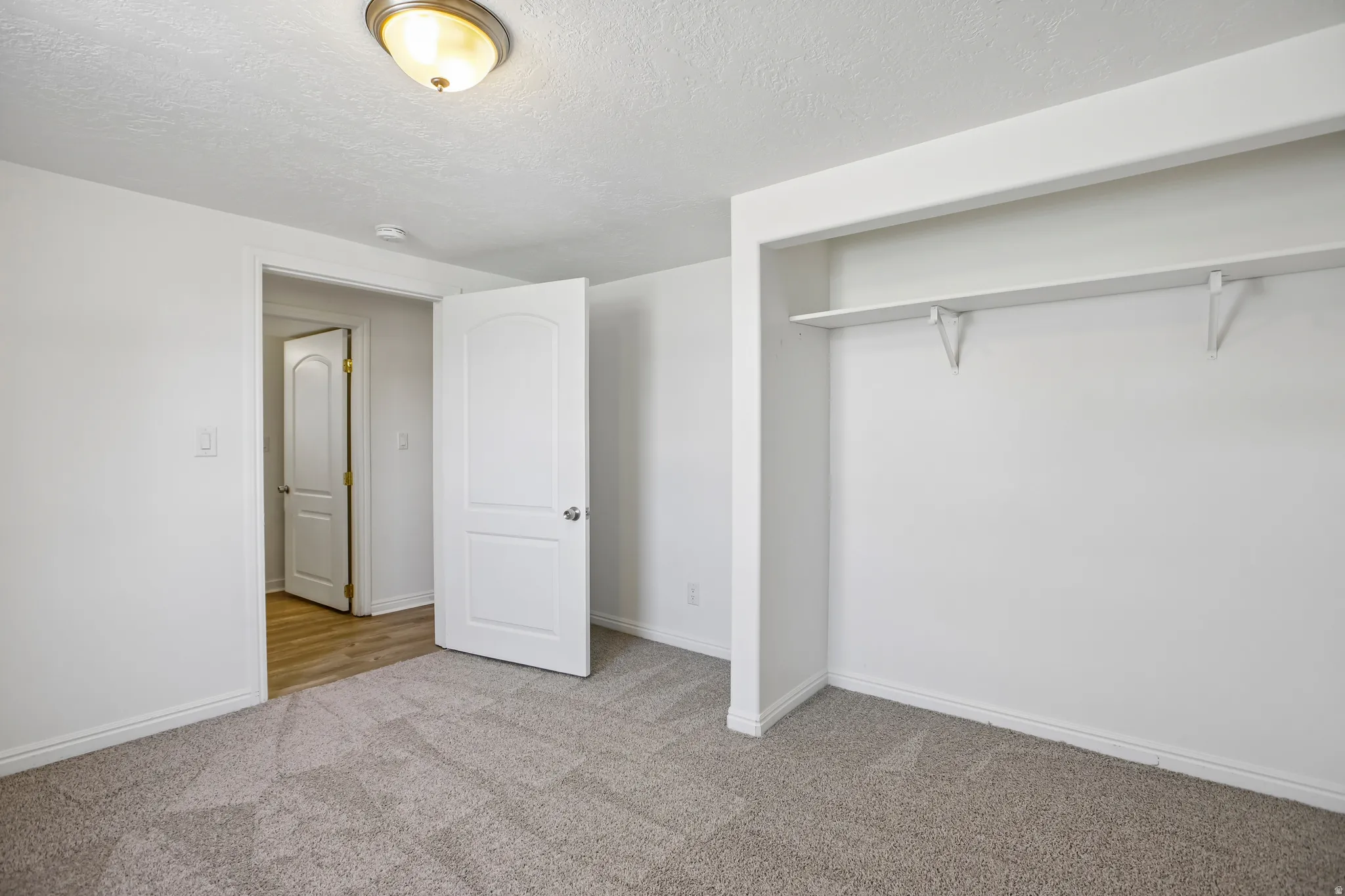 Neutral-toned carpeting paired with white walls