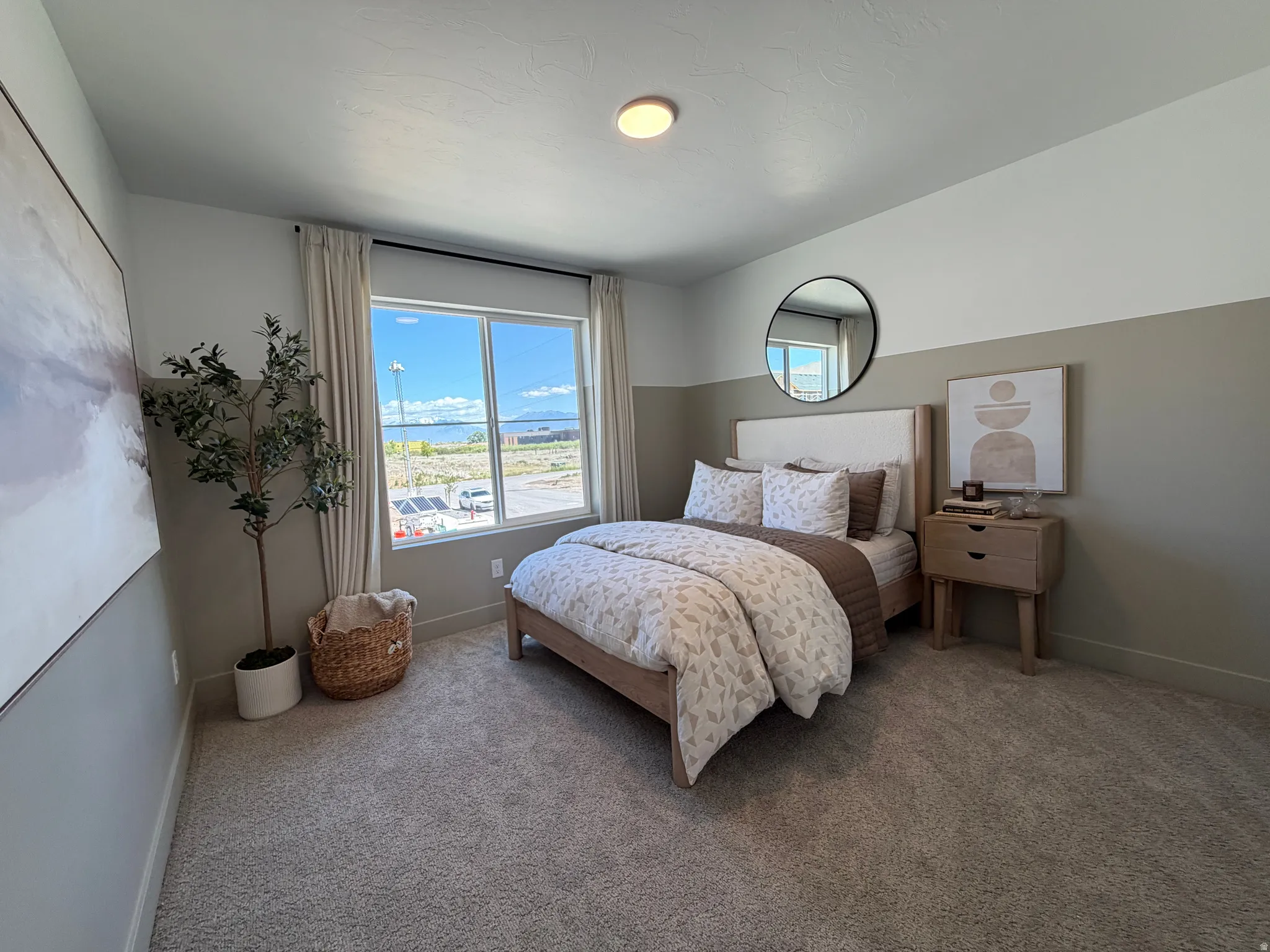 Bedroom featuring a window with exterior views, dual-tone painted walls, and plush carpeting