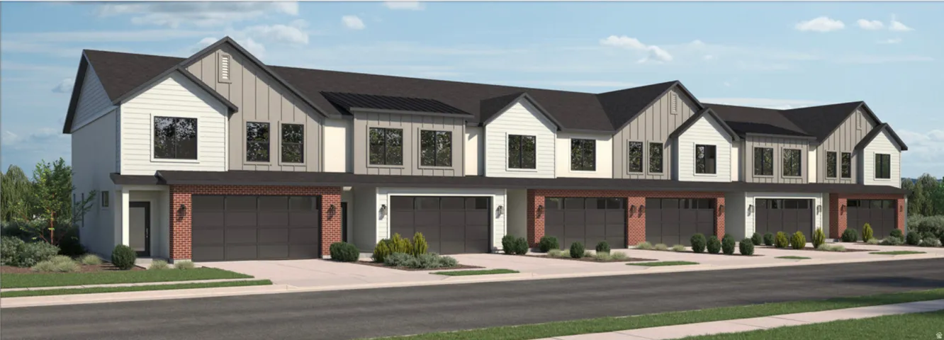 Modern townhome exteriors featuring varied siding, dark-framed windows, and private garages