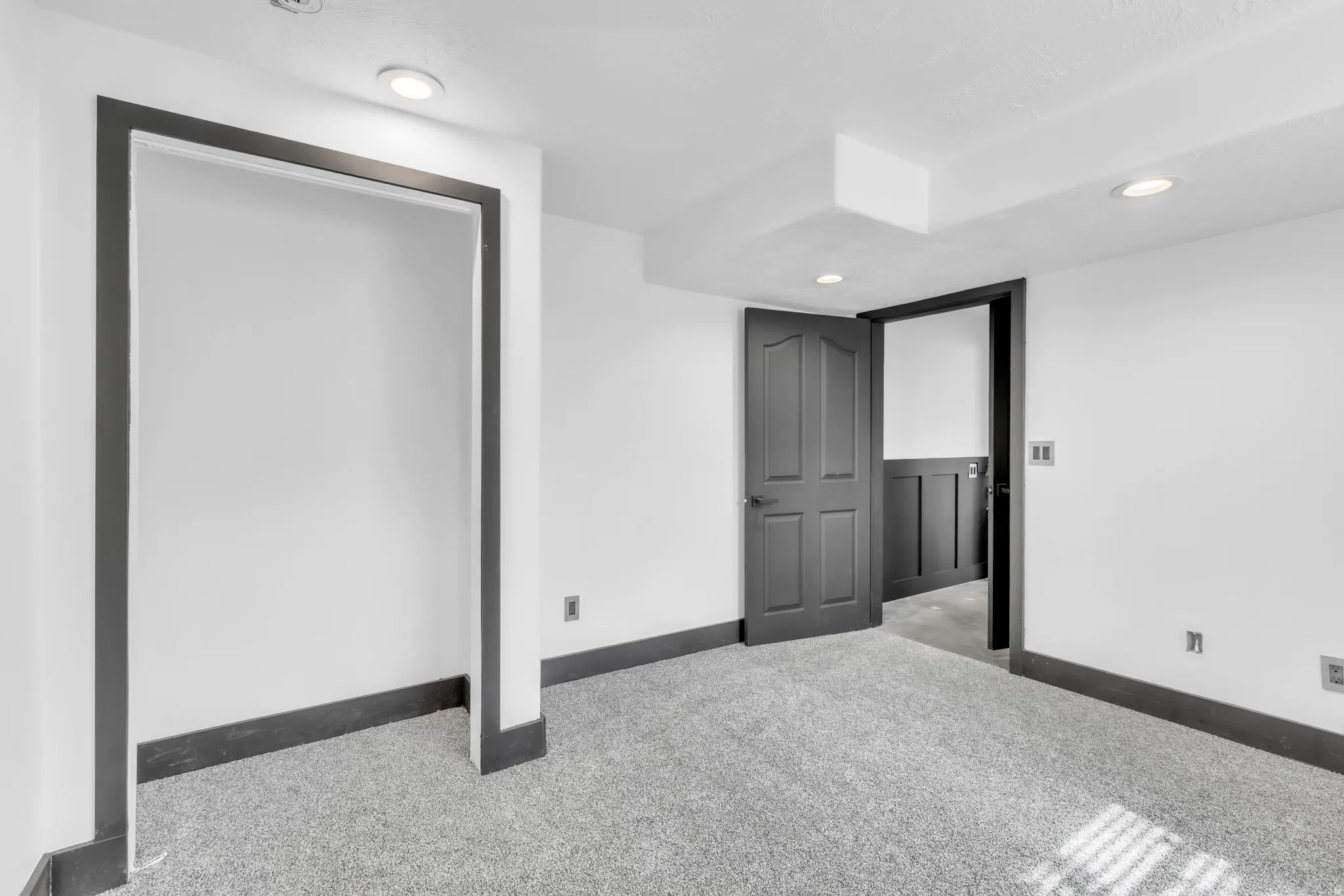 Carpeted room with recessed lighting and white walls