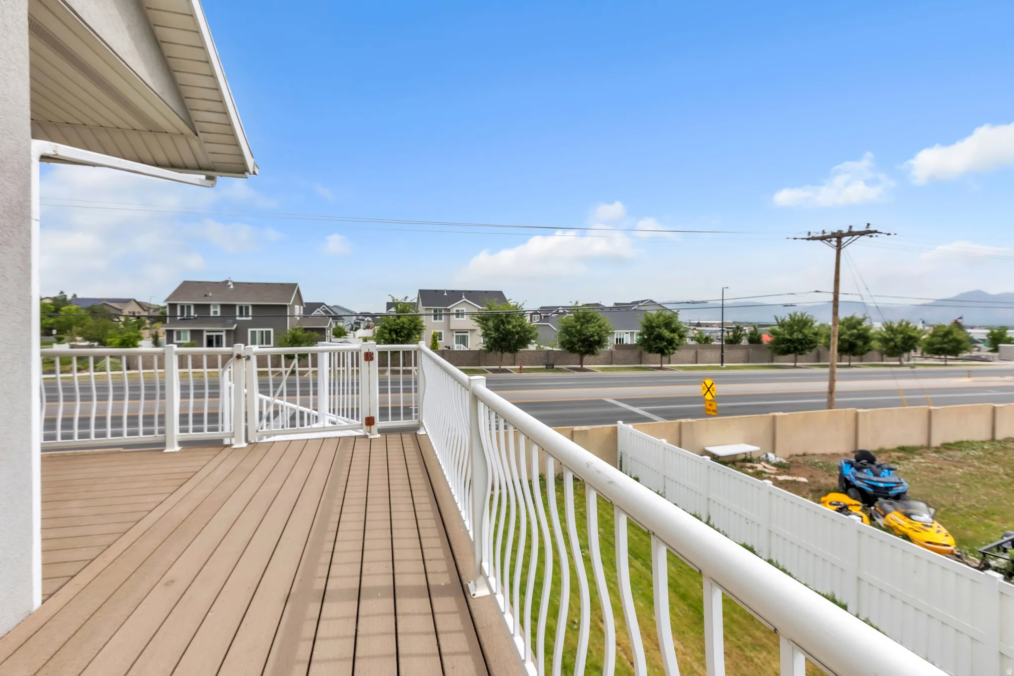 Outdoor deck with wood-finish flooring and white railing