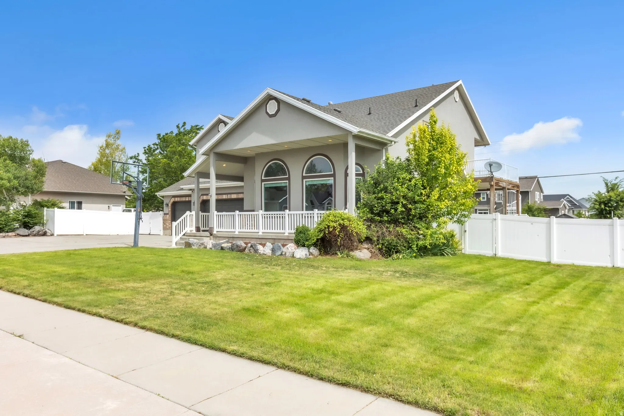 Stucco exterior with a covered front porch featuring white railings