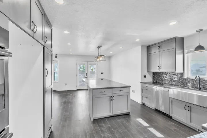Modern kitchen featuring dark wood-finish flooring, recessed lighting, and light gray cabinetry