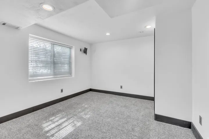 Room featuring light grey carpet flooring and white walls