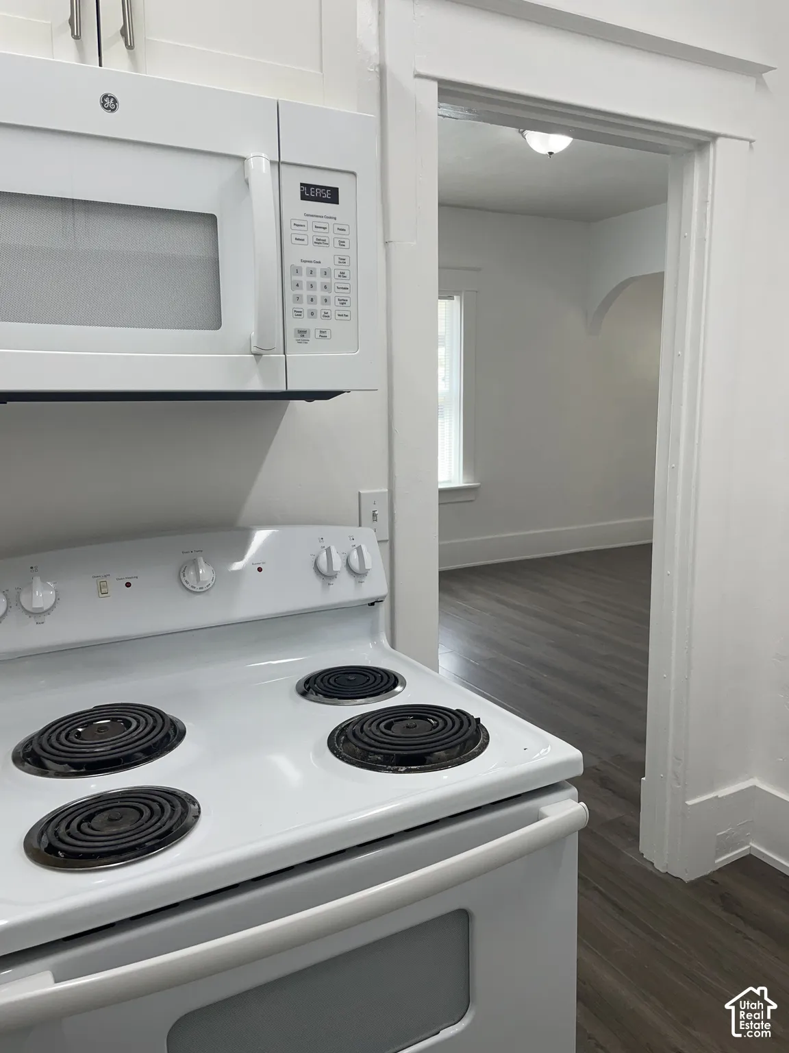 White electric range with coil burners and a matching over-the-range microwave