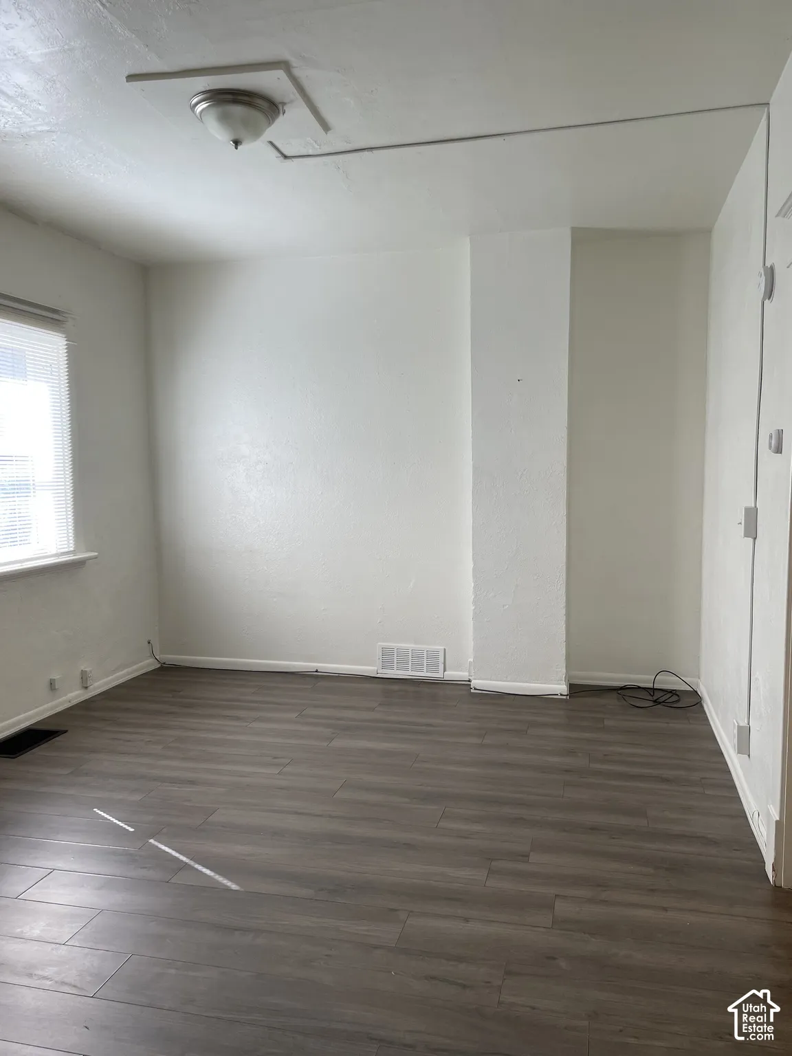Neutral-toned wood-finish flooring complements white walls