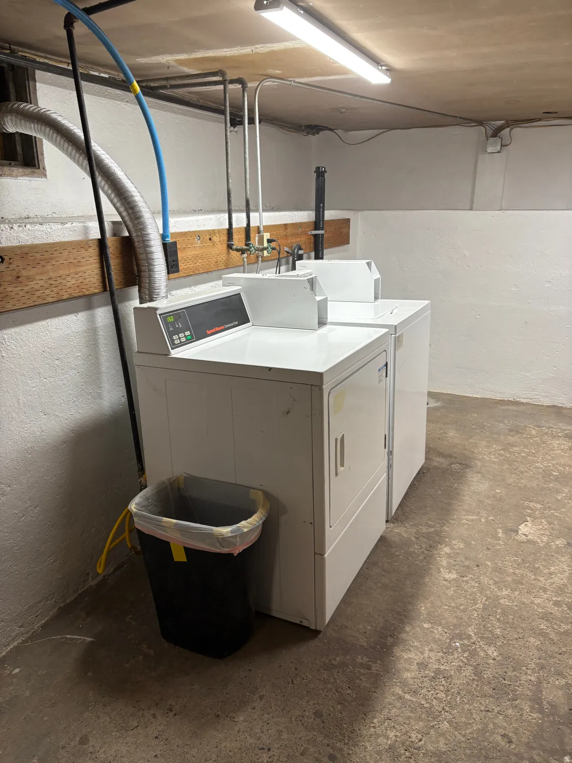 Dedicated laundry area featuring a white washing machine and a white dryer