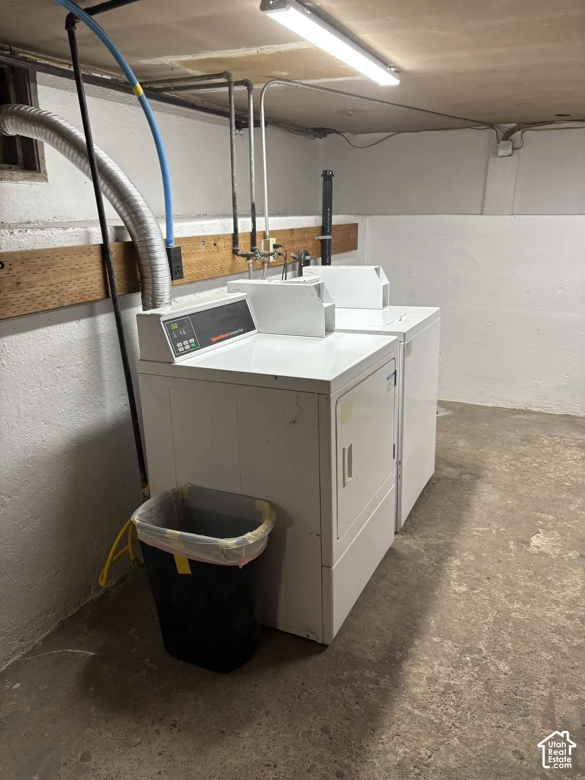 Dedicated laundry area featuring a white washing machine and a white dryer