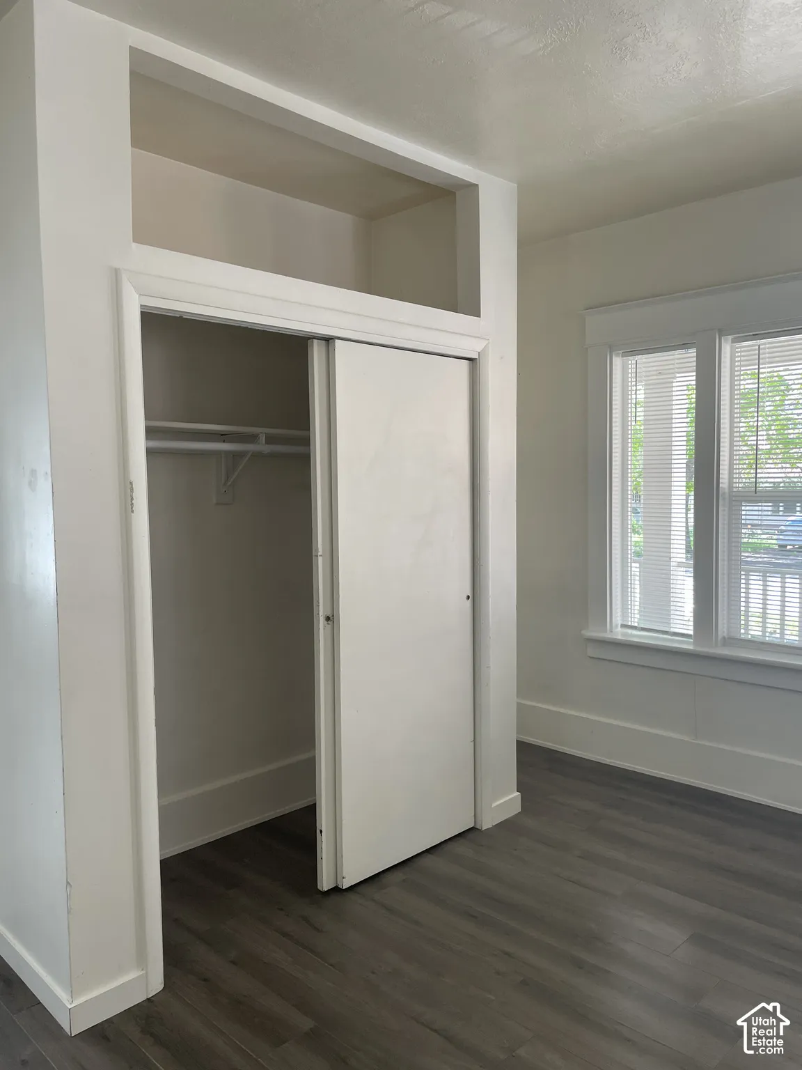 Wardrobe closet with sliding doors and integrated upper storage