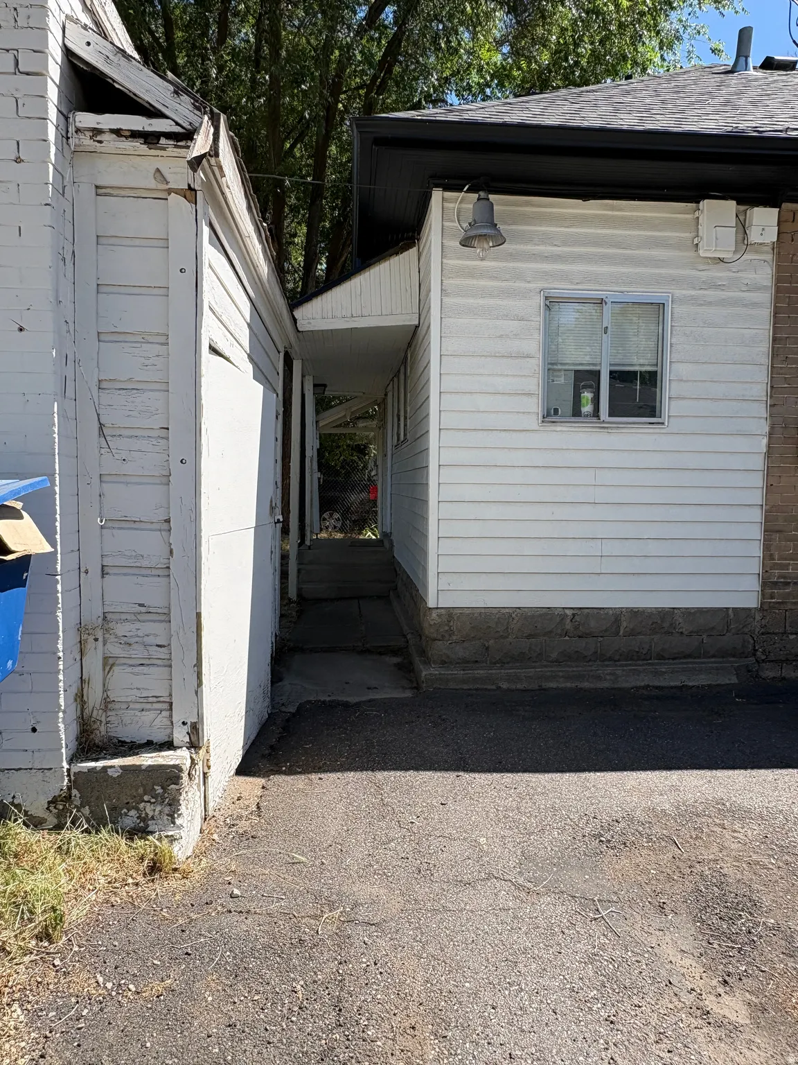 Asphalt driveway providing access to a covered walkway