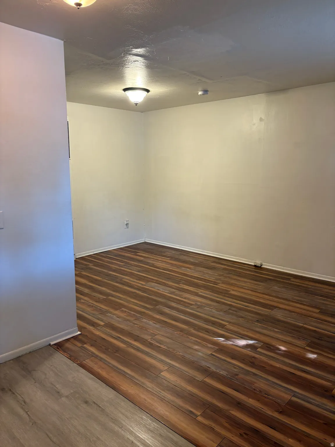 Wood-finish flooring throughout, featuring a distinct plank pattern