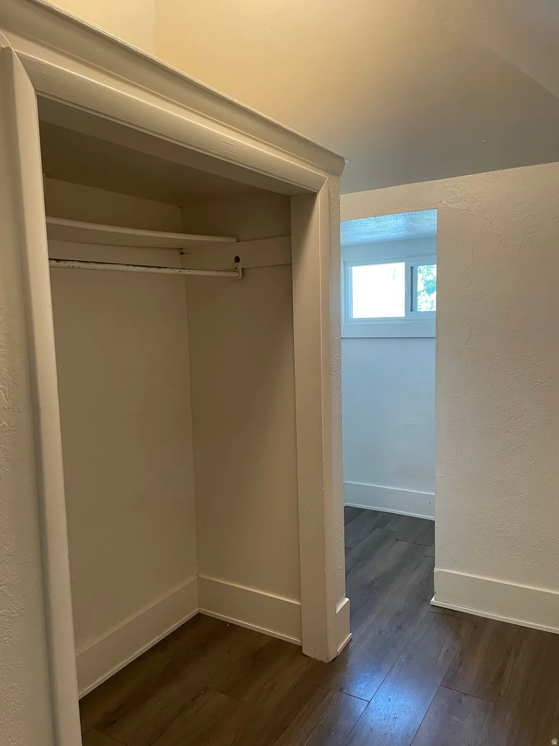 Built-in closet featuring a hanging rod and upper shelf
