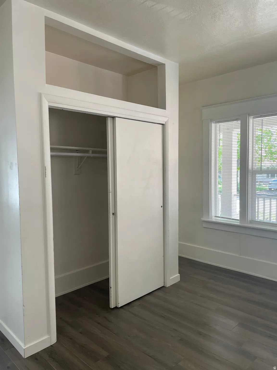 Wardrobe closet with sliding doors and integrated upper storage