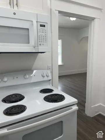 White electric range with coil burners and a matching over-the-range microwave