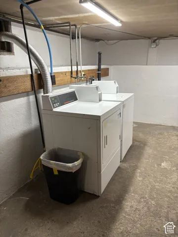 Dedicated laundry area featuring a white washing machine and a white dryer