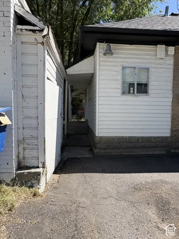 Asphalt driveway providing access to a covered walkway