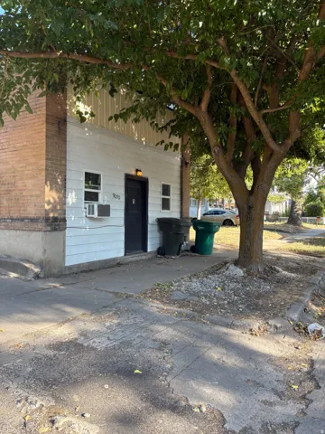 White siding exterior with a brick-clad corner