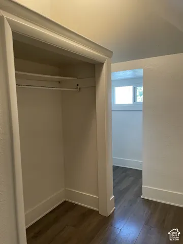 Built-in closet featuring a hanging rod and upper shelf