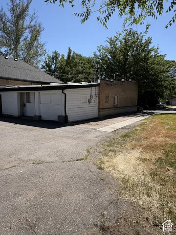 Exterior building featuring white horizontal siding and brick construction