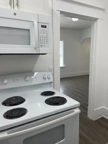 White electric range with coil burners and a matching over-the-range microwave
