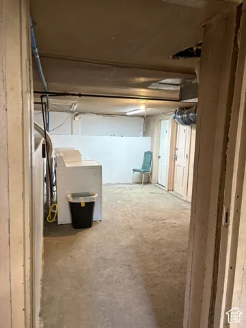 Concrete flooring in a versatile utility space with exposed ductwork and multiple access points