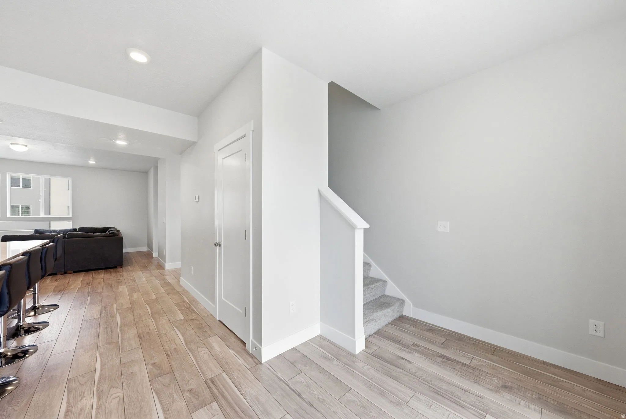 Interior entrance featuring wood-finish flooring, recessed lighting, and a white interior door