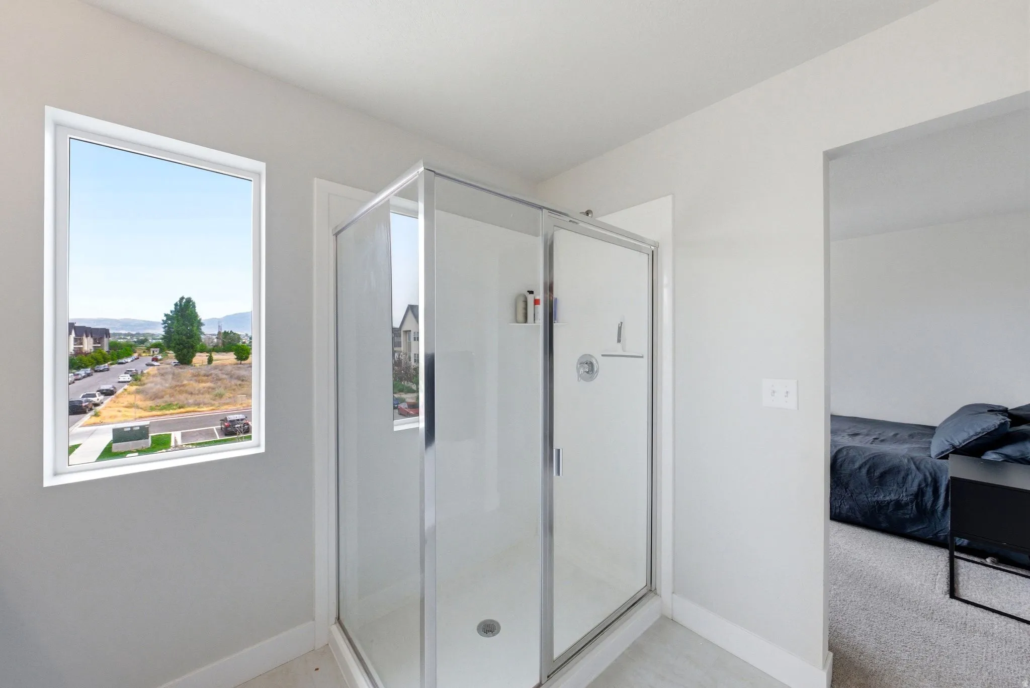 Shower enclosure with a clear glass door and chrome hardware