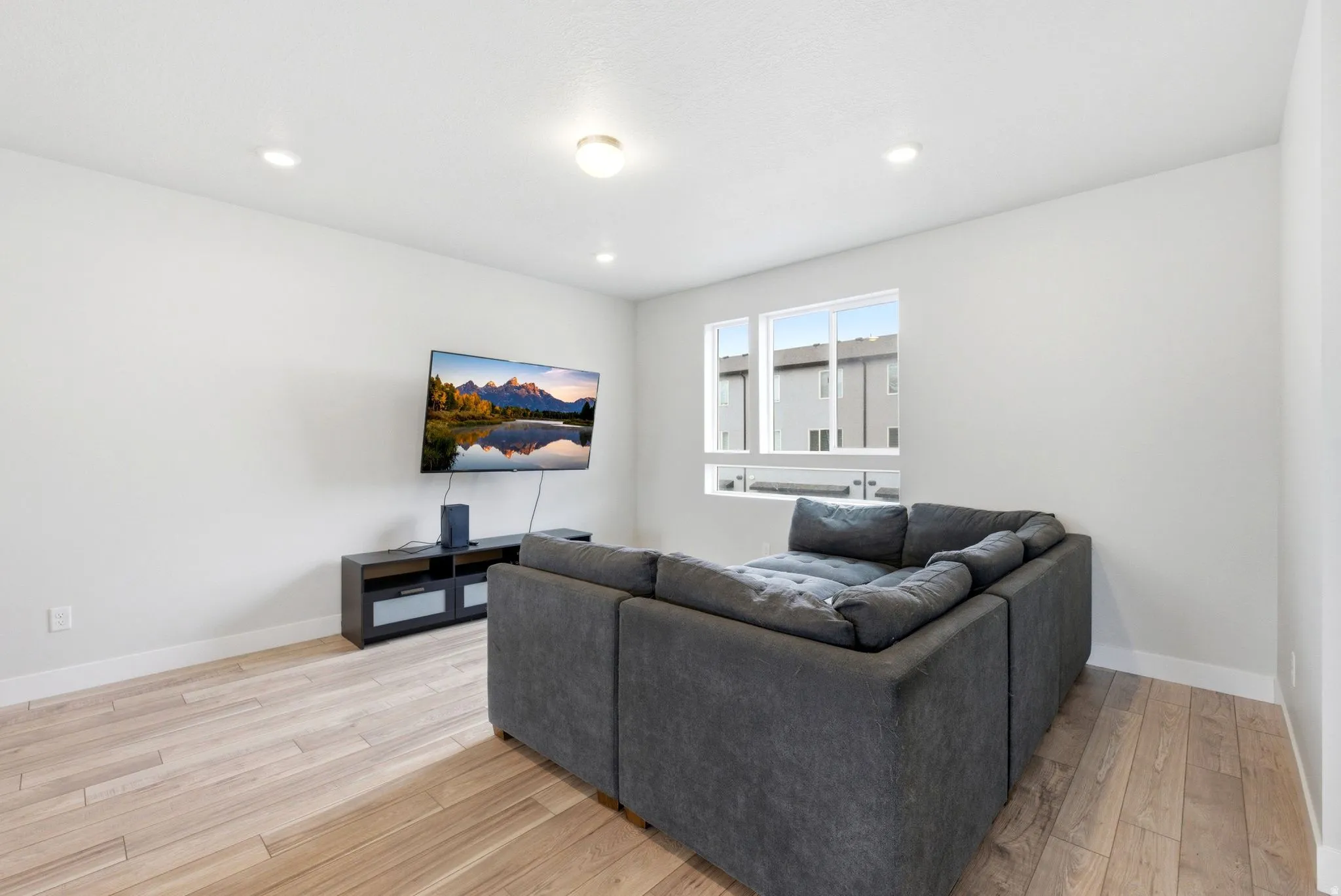 Light wood-finish flooring complements the neutral wall color in this room