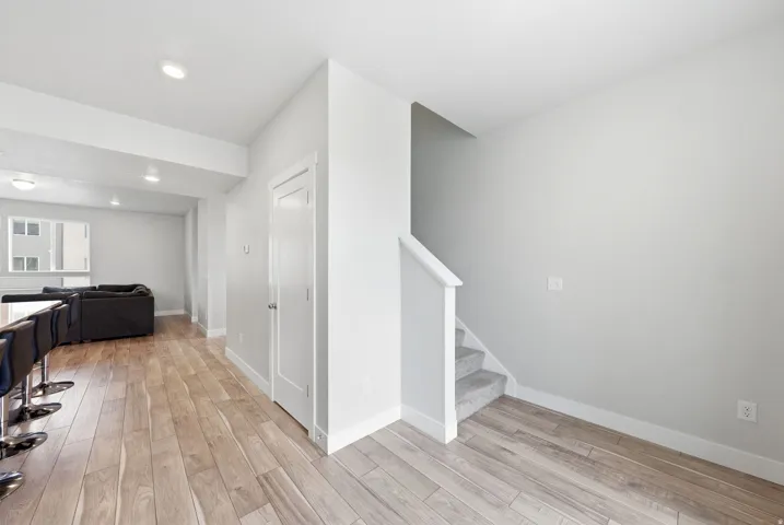 Interior entrance featuring wood-finish flooring, recessed lighting, and a white interior door